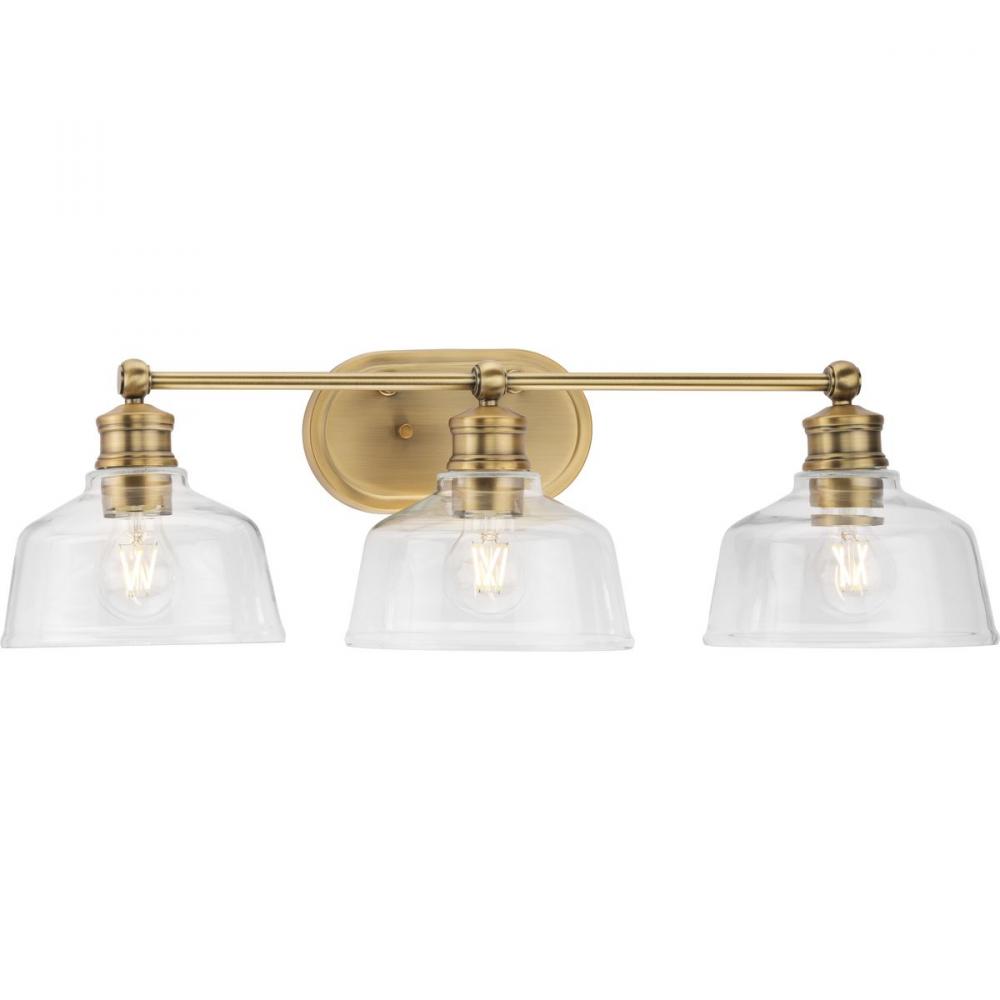 Singleton Collection Three-Light 26.5" Vintage Brass Farmhouse Vanity Light with Clear Glass Sha